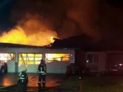 Firefighters douse flames to contain a fire that started early Wednesday morning, Feb. 1, 2017, at a Washougal home.