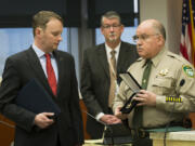 Neil Burkhardt receives a Citizen Service medal from Garry Lucas, then Clark County sheriff, in 2014 for intervening in an office shooting. Burkhardt is among 177 Carnegie Heroes listed in the foundation&#039;s 2015-2016 report, released last week.