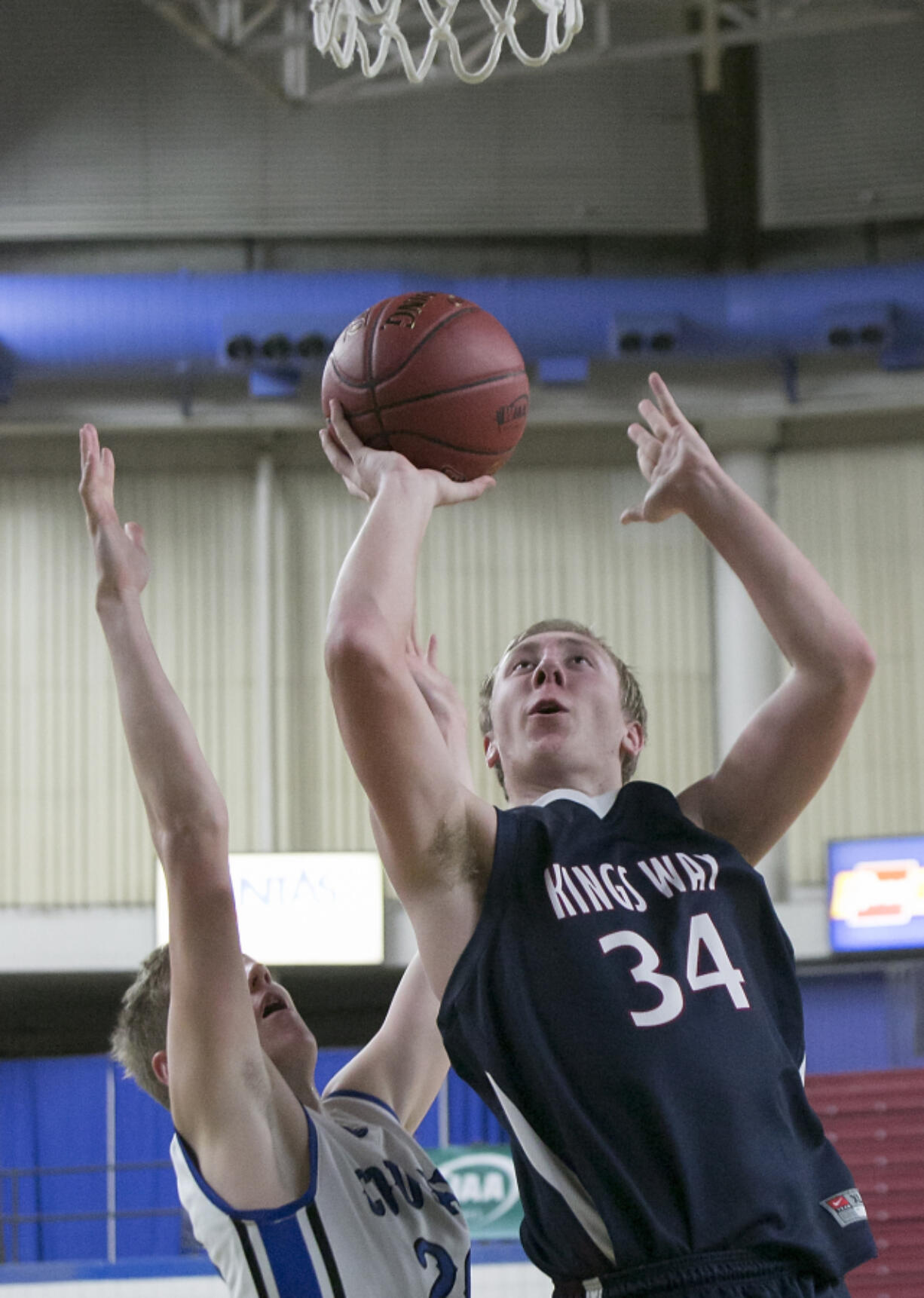 King's Way Christian's Skyler Freeman (34) drives for the basket over Warden's Tanner Skone (20), during the first round of the WIAA 1A boys state tournament.