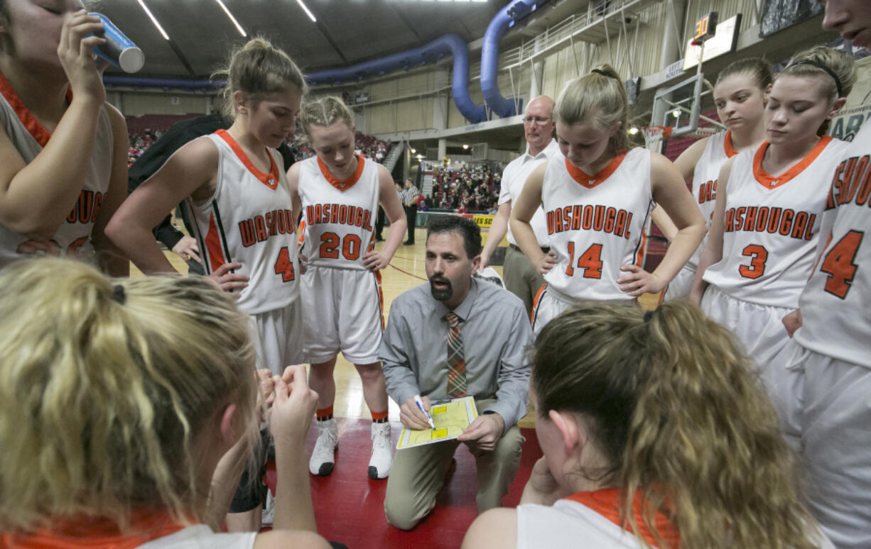 Washougal head coach Brian Oberg talks with his team during the first round of the WIAA 2A girls state tournament on Wednesday, Mar. 1, 2017, at the Yakima Valley SunDome.