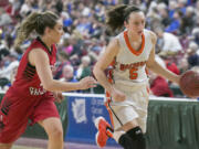 Washougal's Beyonce Bea (5), drives around East Valley's 
 Sydnee Hooker (12), during the first round of the WIAA 2A girls state tournament on Wednesday, Mar. 1, 2017, at the Yakima Valley SunDome. The Washougal Panthers defeated East Valley (Yakima) Red Devils 52-36. (TJ Mullinax/for The Columbian)