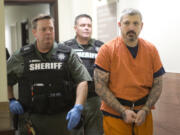 Brent Luyster, the man accused in a Woodland triple homicide and attempted jail escape, is escorted by Clark County corrections deputies to a Nov. 8 court appearance. Prosecutors on Thursday announced they will not seek the death penalty against Luyster who is charged with aggravated murder.