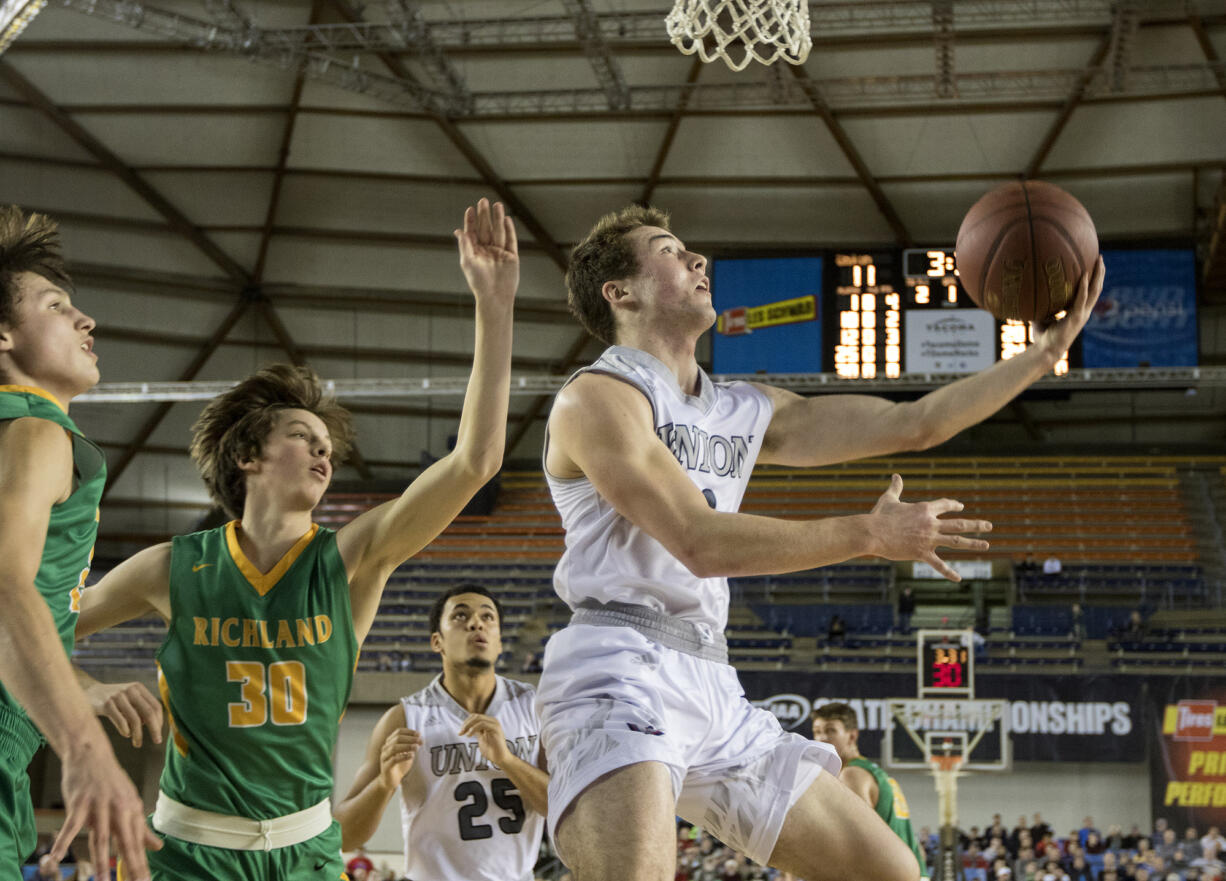 Union's Keithen Shepard gets by two Richland defenders for a lay up attempt Friday, March 3, 2017, during the semi-finals of the 4A Boys State Basketball Tournament in Tacoma, Wash. Union defeated Richland 63-61 to advance to the championship game.