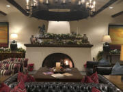 The Wigwam Resort&#039;s main lobby invites visitors to sink into a cozy spot by the fire.