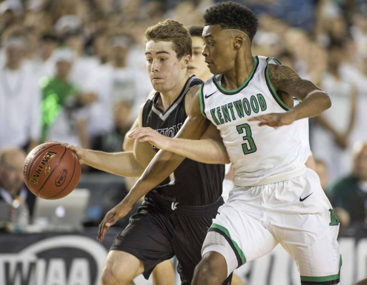 Union's Keithen Shepard, left, dribbles up the court against the defense of Kentwood's Rayvaughn Bolton. Bolton led the Conquerors to a big second half as they pulled away from the Titans to win 81-61 and capture the Class 4A state championship Saturday in Tacoma.