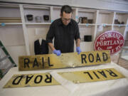 Todd Clark helps assemble a sign for the exhibit that opened Saturday at the Clark County Historical Museum.