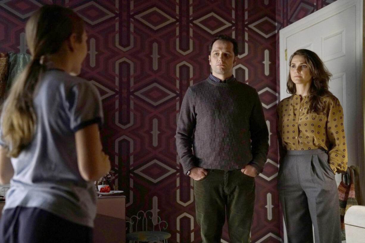 Holly Taylor, from left, Matthew Rhys and Keri Russell star in a scene from &quot;The Americans.&quot; (Patrick Harbron/FX)