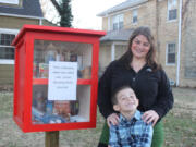 Maggie Ballard and her son Paxton Burns, 6, stand in front of the &quot;Blessing Box&quot; in front of their Wichita, Kan., home. Anyone can come and take food or toiletries as needed, or leave a blessing for someone else.