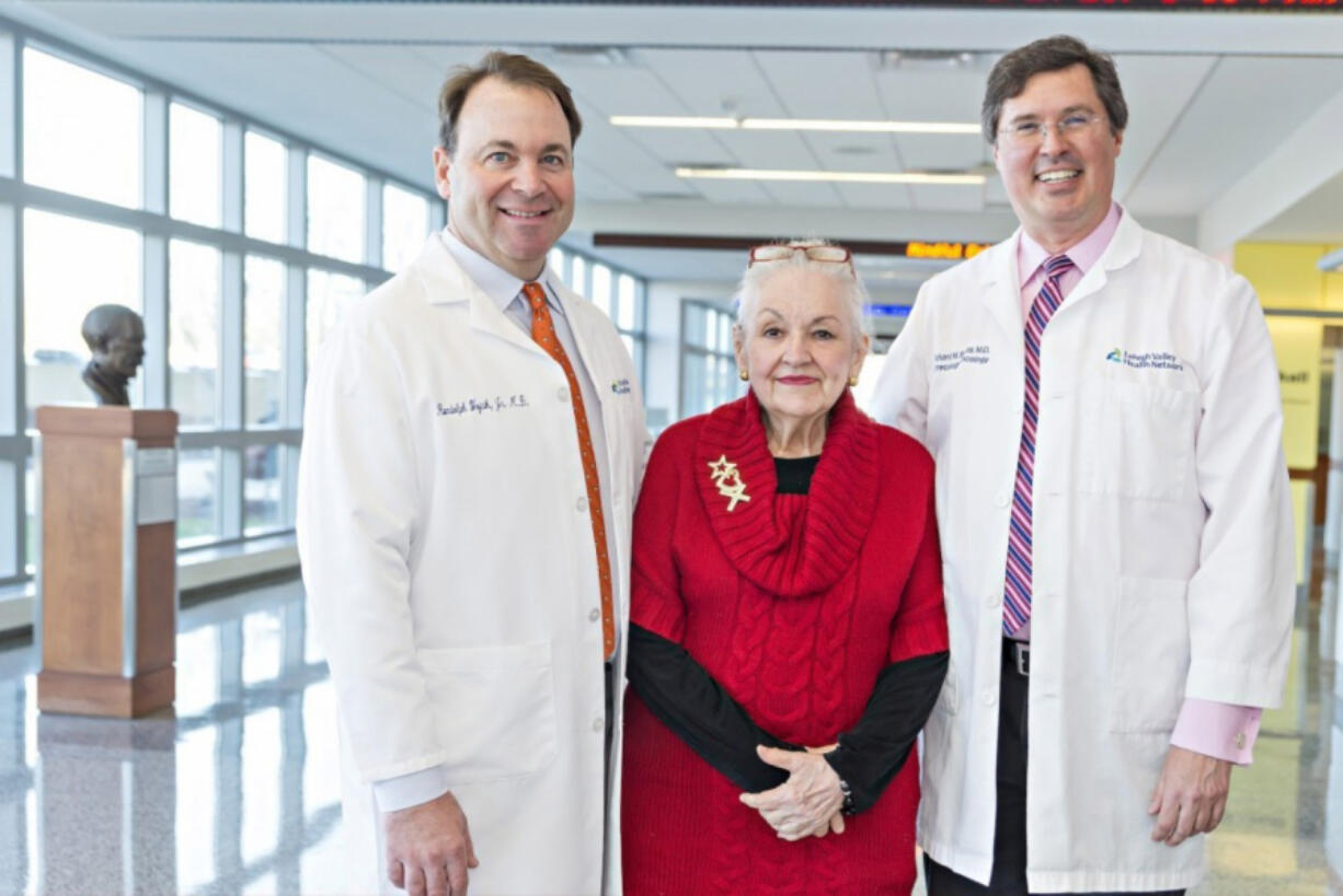 Mary Clancey with physicians Randolph Wojcik Jr., left, and Richard Boulay.