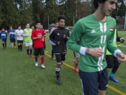 Members of the Fort Vancouver boys soccer team, which includes players who hail from 16 different nations, jog together during practice at Kiggins Bowl on Tuesday.