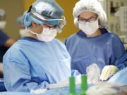 Dr. Storm Dickerson performs a bilateral nipple-sparing mastectomy in 2013 at PeaceHealth Medical Center in Vancouver. At right is Julie Blomdahl, RNFA.