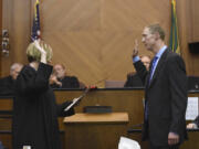 Presiding Clark County District Court Judge Kelli Osler, left, swears in Sleight.