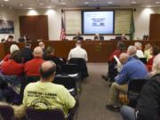 The Port of Vancouver board of commissioners listen to public testimony before voting on whether or not to cancel the Vancouver Energy oil terminal lease at the Port of Vancouver on Tuesday.