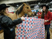 Kate Hudgin, left, and Graci Dissen speak Sunday about horse Diesel and the Windhaven Therapeutic Riding program for veterans.