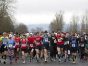 Racers take off from the starting line Feb. 26 as they take part in the Vancouver Lake half-marathon in Vancouver.