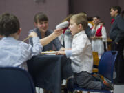 Tanya Andersen gives her son, Mark, 2, a spoonful during Bethel Lutheran Church&#039;s 100th anniversary smorgasbord lunch celebration Sunday, held in honor of the church&#039;s  centennial.