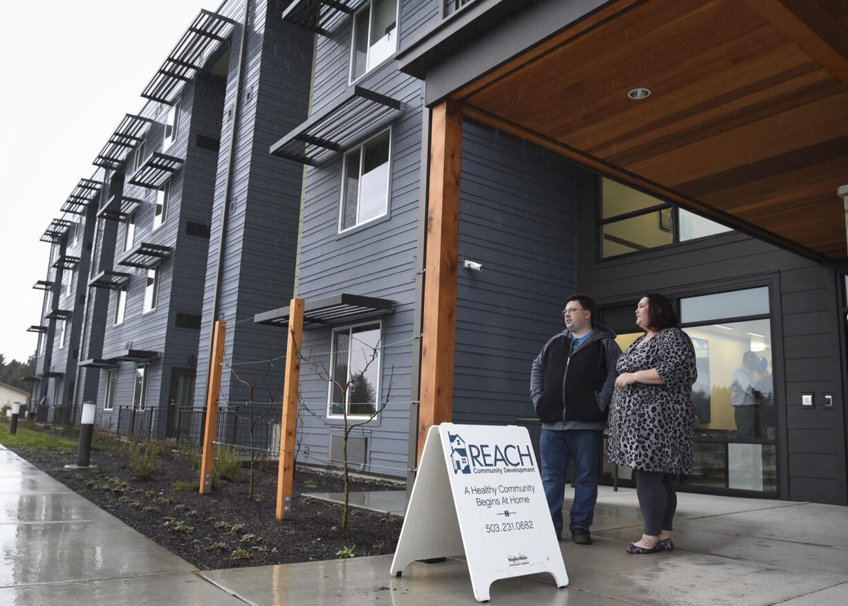 Reach Community Development employee Rachael Meeks, right, and her husband, William Meeks, stand outside Isabella Court and look at a plot of land where Isabella Court II will be built. The couple live off Fourth Plain Boulevard and are interested to see how all of the planned developments will change the area.