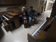 Surrounded by pianos, executive director Cheri Martin, left, and head piano technician and instructor Leal Sylvester discuss the fate of the School of Piano Technology for the Blind on Thursday afternoon. The school does good business in piano repairs and sales, but it&#039;s completely out of students, Martin said.