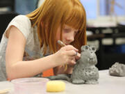 Union Ridge Elementary School third-grader Ella Rupp, 8, sculpts a monster in class during the Ridgefield Youth Arts Month Program, which allows students to try out different arts in mostly free classes.