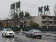 Motorists pass by the former Red Lion Hotel Vancouver at the Quay as construction fencing surrounds the hotel.