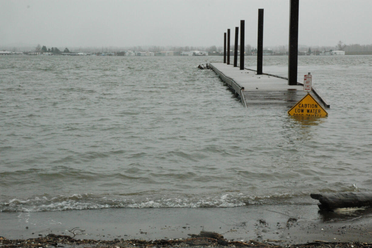 A flood warning has been issued for the Columbia River as waters approach the minor flood stage, overtaking a portion of the dock Wednesday at the Marine Park boat ramp in Vancouver.