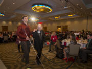 Cody Hermeling, left, is escorted by his mom, Kathleen Boniface, after being honored by the American Red Cross as the Blood Donation Hero. Hermeling, a victim in a head-on crash, has held a blood drive on the anniversary of the crash, leading to the collection of more than 300 units of blood.