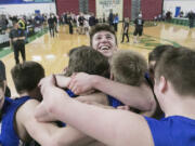 La Center&#039;s Matt Baher is surrounded by Wildcat teammates as time runs out against Newport during the WIAA 1A boys state tournament finals, on Saturday, Mar. 4, 2017 at the Yakima Valley SunDome. La Center defeated Newport 51-38, winning fourth place.