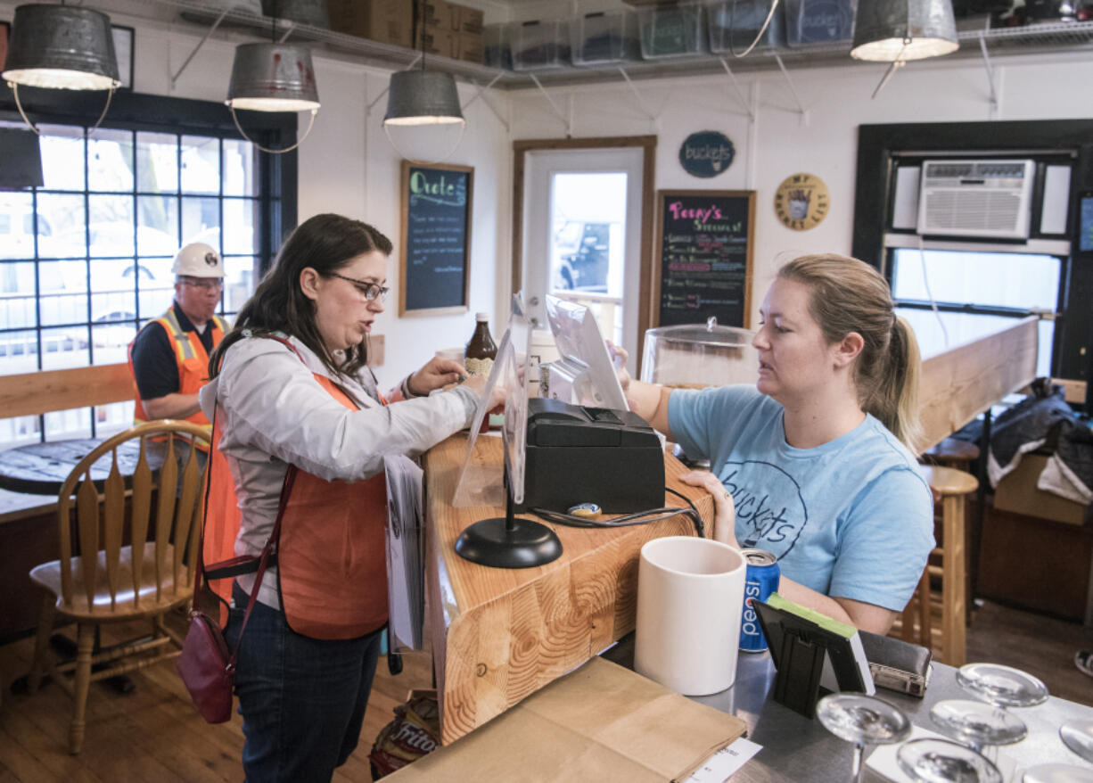 Stephanie Moore, right, takes Ilani Casino Resort employee Niki Strano&#039;s order at Buckets restaurant in Ridgefield. With the casino weeks from opening, nearby business owners are hoping the influx of visitors trickle out to the rest of north Clark County, while city officials are gearing up for potential negative financial impacts from the casino.