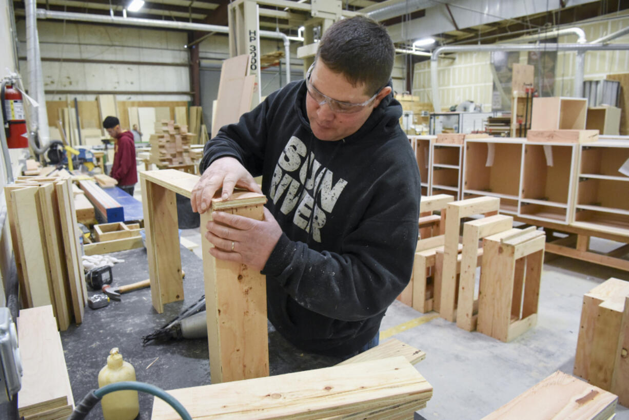 John Werner assembles a cabinet at Trobella Cabinetry. Trobella Cabinetry is one of the many manufacturers that have put the Port of Vancouver at 99 percent occupancy.