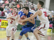 La Center guard, Hunter Ecklund (23), is stripped of the ball by King's Knights' Hunter Reeves (2) and Nate Kleppe (22), during the second round of the WIAA 1A boys state tournament on Thursday, Mar. 2, 2017, at the Yakima Valley SunDome. King's Knights defeated La Center Wildcats 51-48.