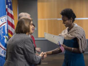 Vancouver Community Library manager Jackie Spurlock, left, congratulates new American citizen Fiyori Hagos, a Portland resident from Ethiopia, after the swearing-in ceremony Friday morning at the library.