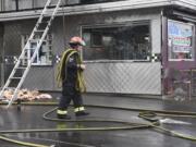 The Vancouver Fire Department cleans up after a fire at Igloo Restaurant in Vancouver on Monday.