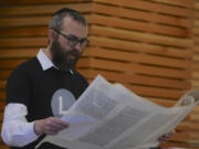 Rabbi Shmulik Greenberg reads the Megillah, or the story of the Book of Esther, at the Purim holiday celebration.