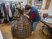 Eileen Trestain, seamstress and wardrobe department manager for Fort Vancouver National Historic Site, works on a silk dress from about 1855.