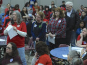 Susan Nystrom, left, asks a question as teachers, parents and public school supporters rally at a forum with legislators Saturday at Roosevelt Elementary School in Vancouver.