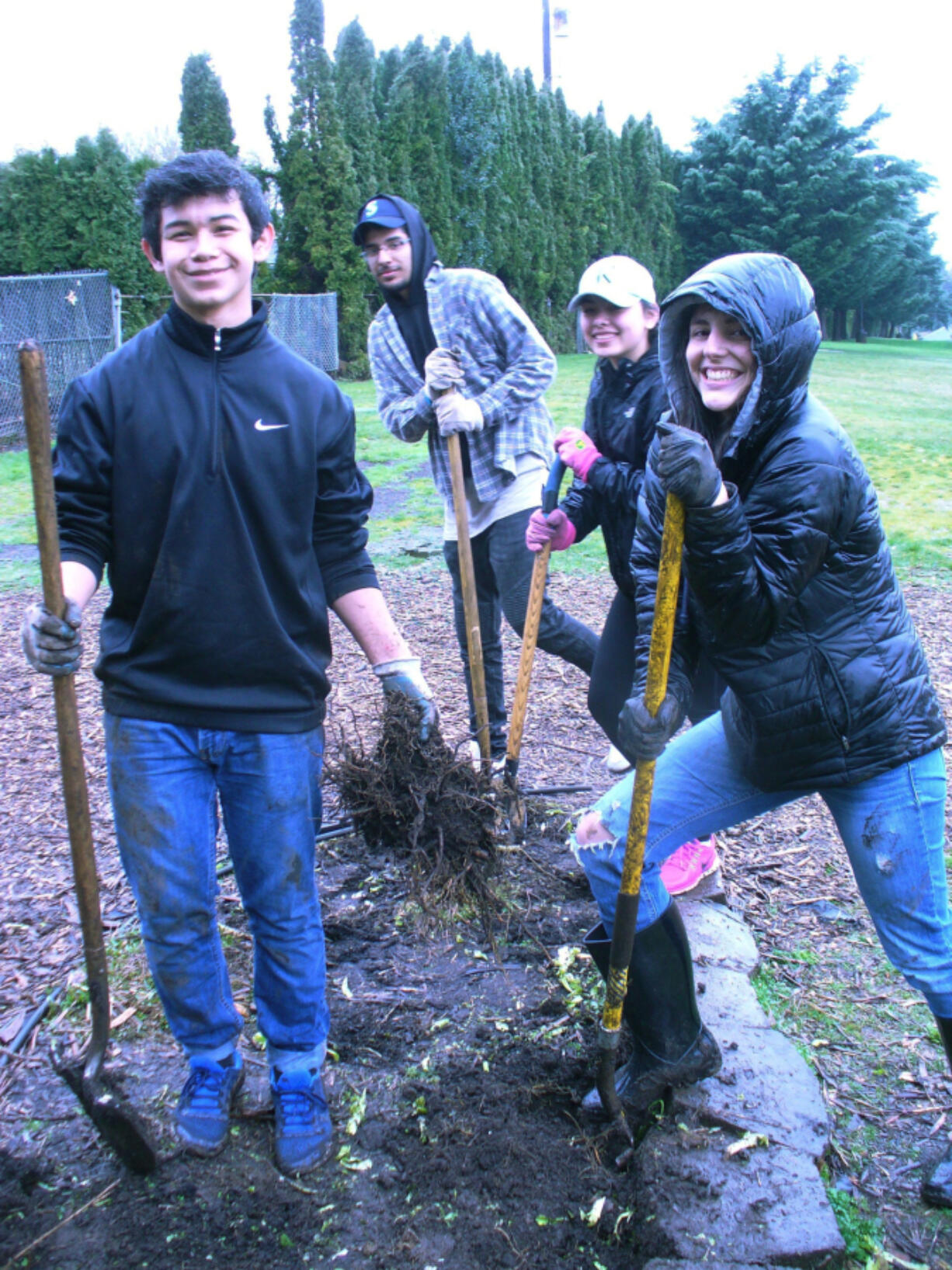 Hazel Dell: Forty-four Food and Your Health students from Clark College, including Arnold Vasquez, from left, Juan Carlos, Maia Kment and Faith Wirchak helped get the Hazel Dell School and Community Garden ready for the spring during work parties held earlier this month.