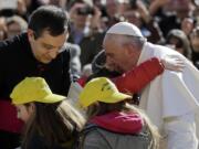 Pope Francis greets children after they drove with him on his car as he toured St.Peter's Square, at the Vatican, upon his arrival for his weekly general audience, Wednesday, March 1, 2017.