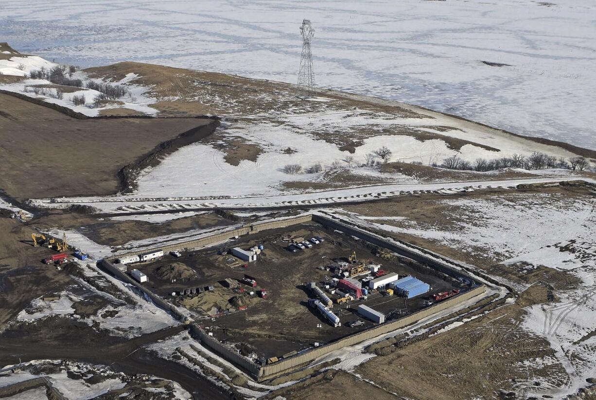 FILE - In this Feb. 13, 2017, aerial file photo shows the site where the final phase of the Dakota Access Pipeline will take place with boring equipment routing the pipeline underground and across Lake Oahe to connect with the existing pipeline in Emmons County near Cannon Ball, N.D. Sioux tribes suing to stop the Dakota Access pipeline want a federal judge to head off the imminent flow of oil. Judge James Boasberg on March 7, 2017, rejected the request of the Standing Rock and Cheyenne River Sioux to stop construction of the final segment of the pipeline that would move oil from North Dakota to Illinois.