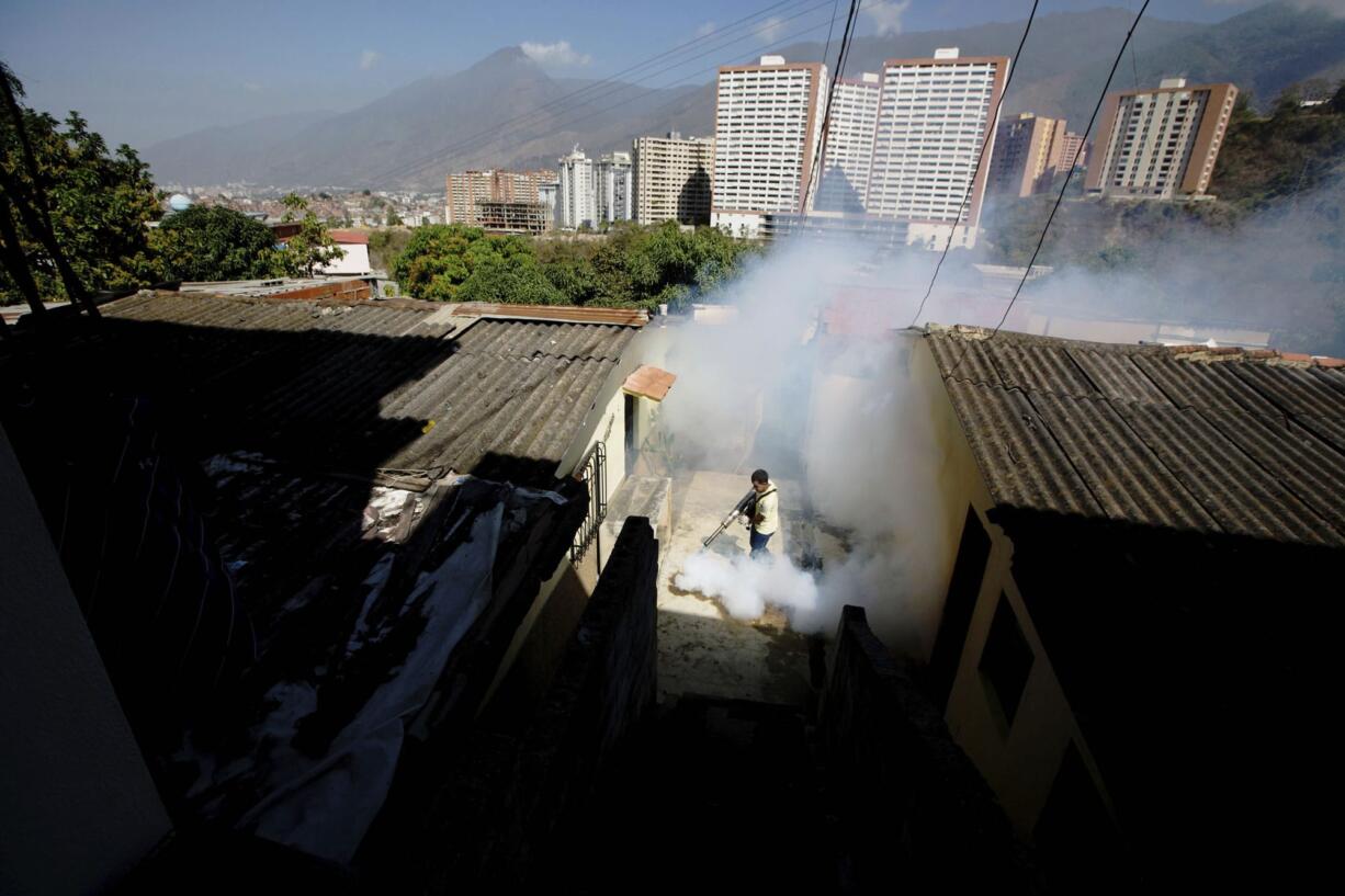 FILE - In this Monday, Feb. 1, 2016 file photo, a Sucre municipality worker fumigates for Aedes aegypti mosquitoes that transmit the Zika virus in the Petare neighborhood of Caracas, Venezuela. Ahead of the annual American College of Cardiology conference in Washington in March 2017, doctors say they have tied infection with the Zika virus to possible new heart problems in adults. The evidence is only in eight people in Venezuela and does not prove a link. It's too soon to know how often this might be happening, although it seems less common than the troubles the mosquito-borne virus has been causing for pregnant women and their fetuses.