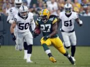 Green Bay Packers running back Eddie Lacy (27) rushes against the Oakland Raiders during the first half of an NFL preseason football game in Green Bay, Wis.  Lacy's agent says the former Green Bay running back is joining the Seattle Seahawks. Lacy's management group, Sports Trust Advisors, said Tuesday, March 14, 2017, on Twitter that the four-year veteran has agreed to terms with the Seahawks.