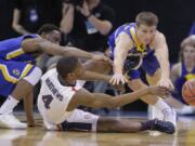 Gonzaga guard Jordan Mathews (4) passes the ball as South Dakota State's Tevin King, left, and Lane Severyn, right, defend during the first half of a first-round men's college basketball game in the NCAA Tournament, Thursday, March 16, 2017, in Salt Lake City.