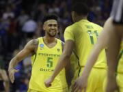 Oregon guard Tyler Dorsey (5) celebrates with Keith Smith (11) at the end of a regional semifinal against Michigan in the NCAA men's college basketball tournament, Thursday, March 23, 2017, in Kansas City, Mo. Oregon won 69-68.