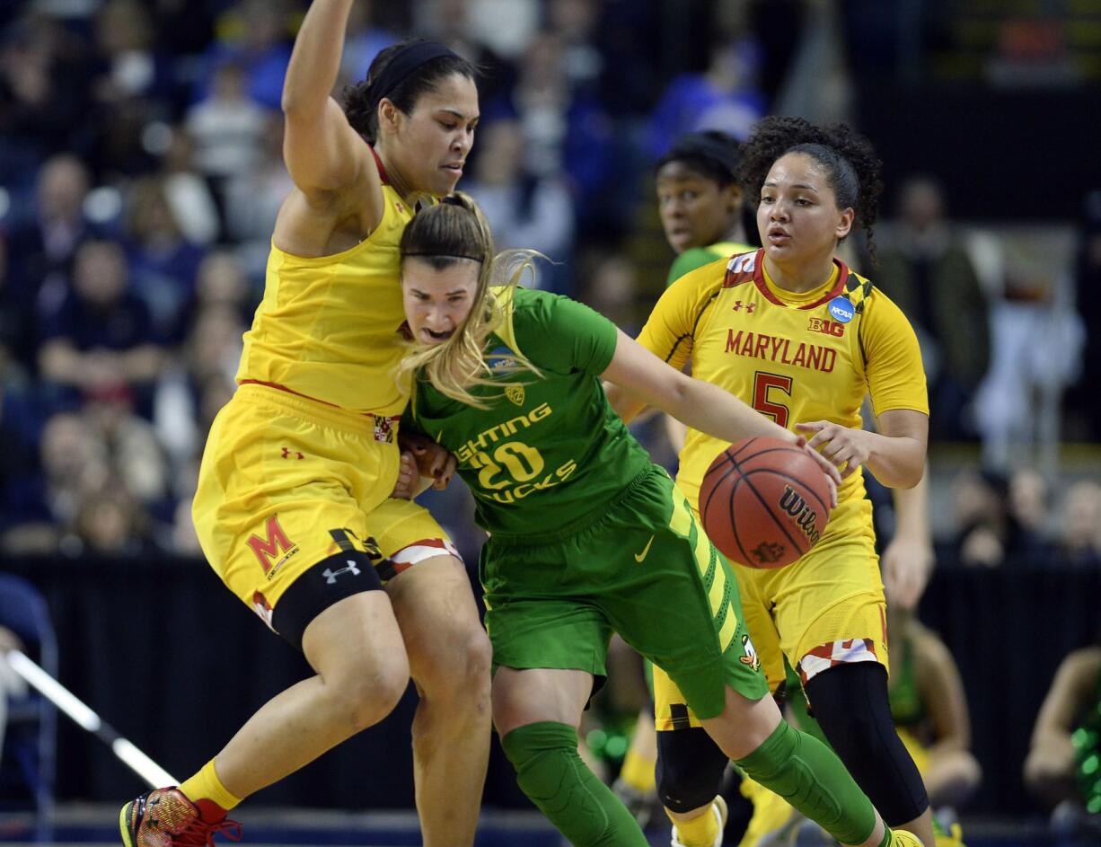 Oregon's Sabrina Ionescu, right, tries to drive against Maryland's Brionna Jones, left, during the second half of a regional semifinal game in the NCAA women's college basketball tournament, Saturday, March 25, 2017, in Bridgeport, Conn.