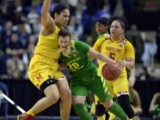 Oregon's Sabrina Ionescu, right, tries to drive against Maryland's Brionna Jones, left, during the second half of a regional semifinal game in the NCAA women's college basketball tournament, Saturday, March 25, 2017, in Bridgeport, Conn.