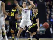 Oregon's Sabrina Ionescu, right, tries to gather the ball after running into the defense by Connecticut's Kia Nurse during the first half of a regional final game in the NCAA women's college basketball tournament, Monday, March 27, 2017, in Bridgeport, Conn.