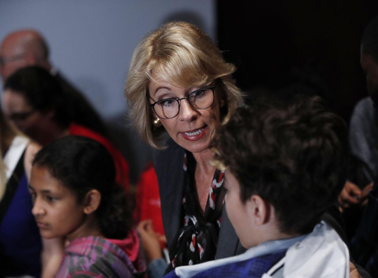 Education Secretary Betsy DeVos talks to students at the Smithsonian's National Air and Space Museum in Washington, Tuesday, March 28, 2017, during an event to celebrate Women's History Month.