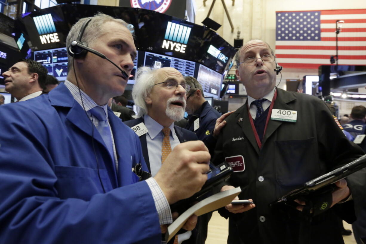 Traders Timothy Nick, left, Peter Tuchman, center, and Gordon Charlop work on the floor of the New York Stock Exchange on Thursday.