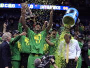 Oregon players celebrate with coach Dana Altman after a Midwest Regional final against Kansas in the NCAA men&#039;s college basketball tournament, Saturday, March 25, 2017, in Kansas City, Mo. Oregon won 74-60.