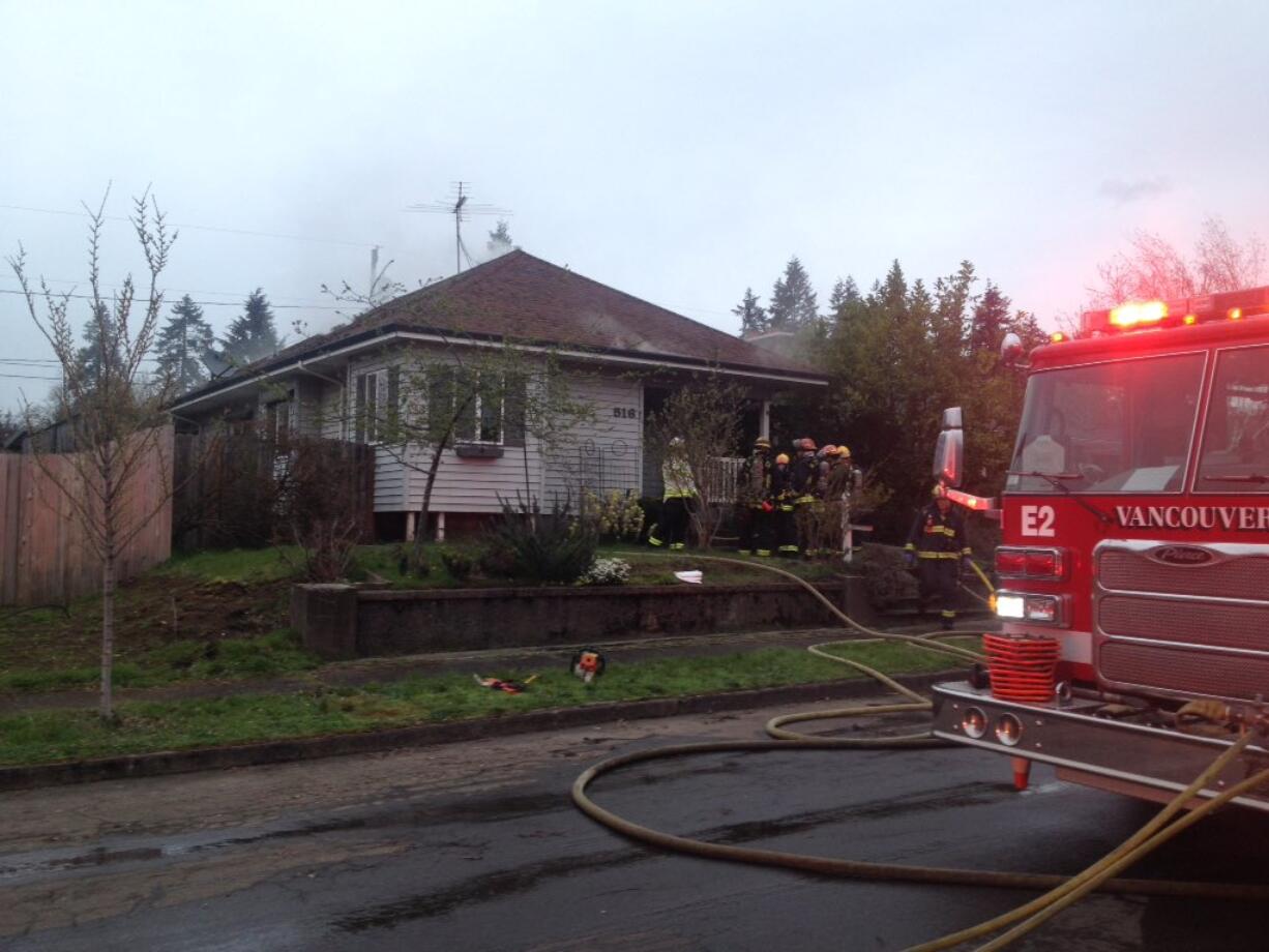 Firefighters work at the scene of a house fire reported on West 30th Street Tuesday evening.