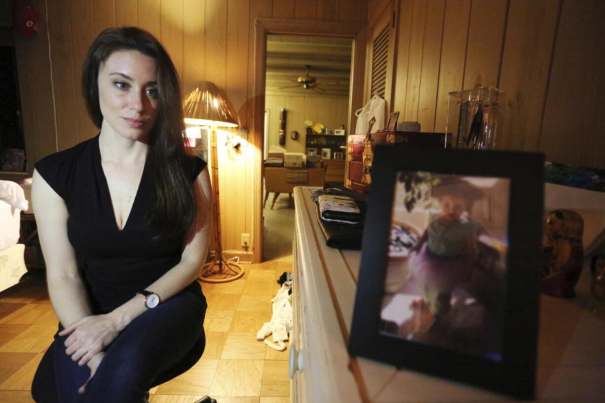 Casey Anthony poses for a portrait next to a photo of her daughter, Caylee, in her West Palm Beach, Fla., bedroom.